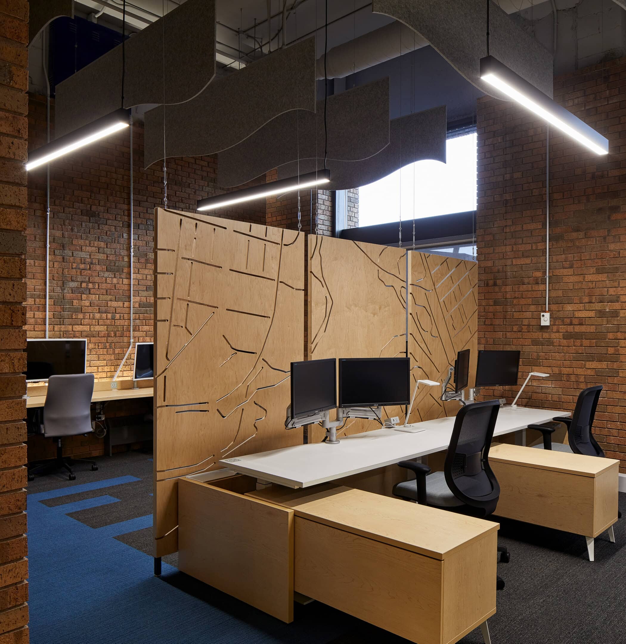 Pendant lighting over the workstations at GCworkplace, Gatineau