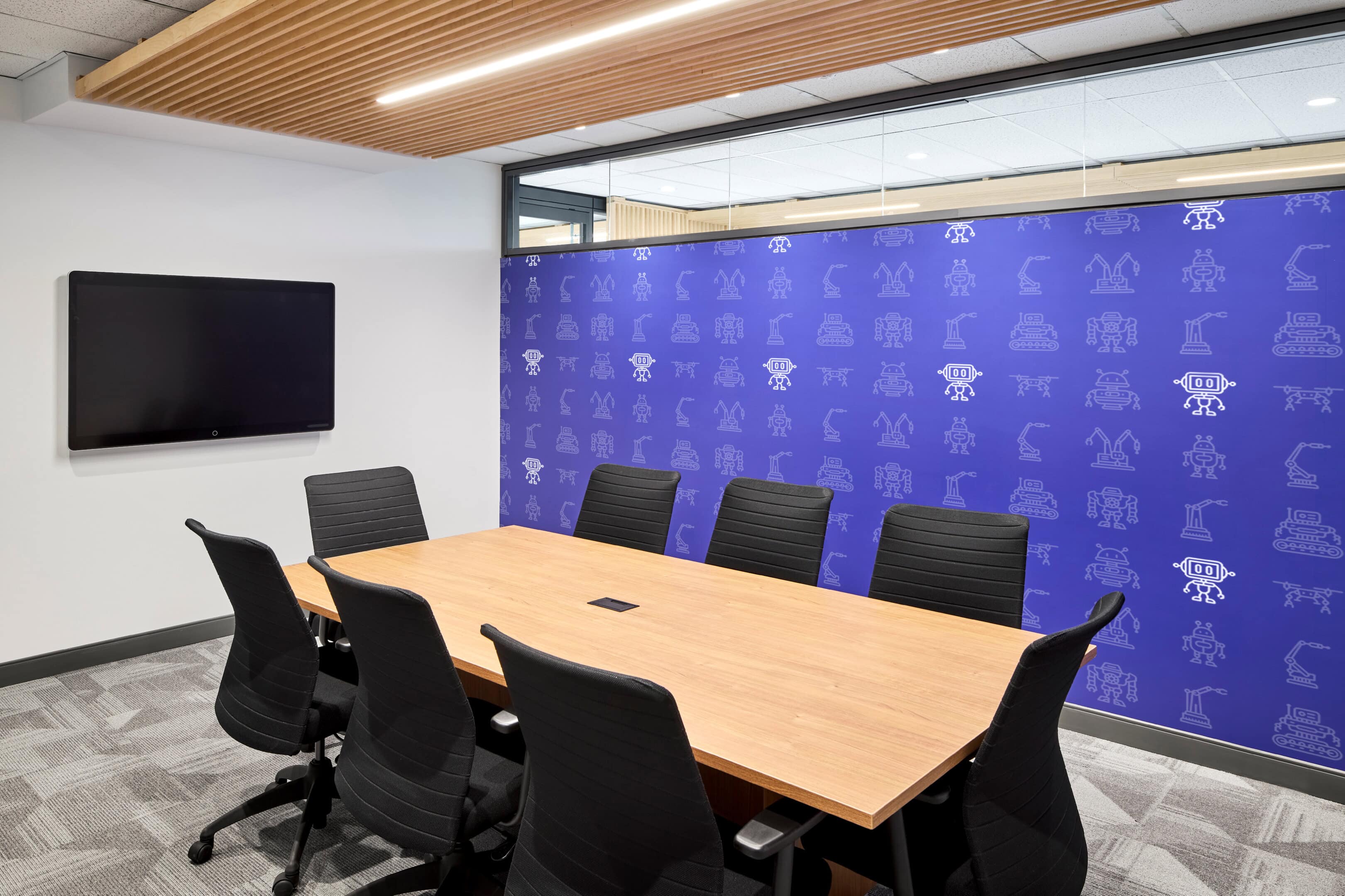 Meeting room lighting with cove lighting and mural accent wall at GC Workplace, Ottawa