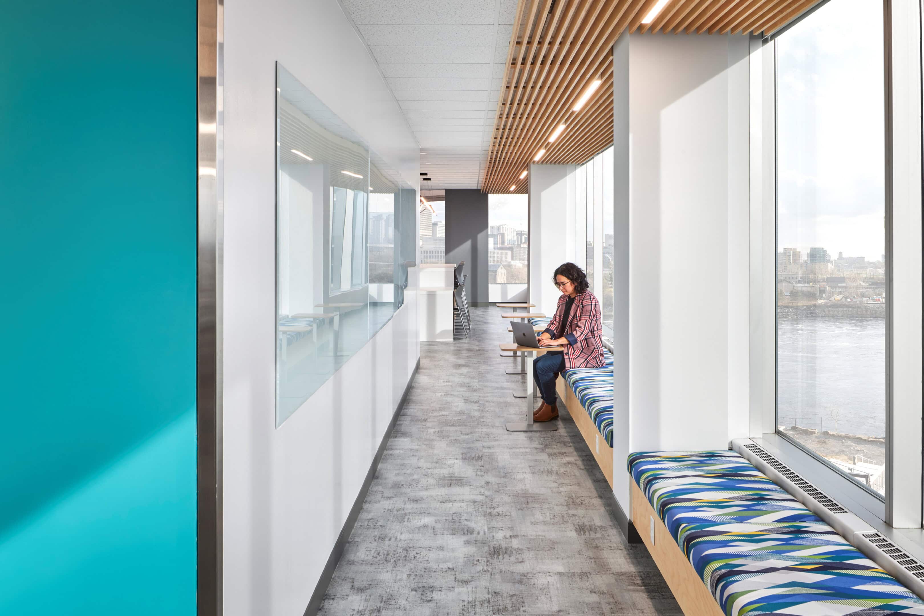 Corridor lighting with recessed downlights along window seating at GC Workplace, Ottawa