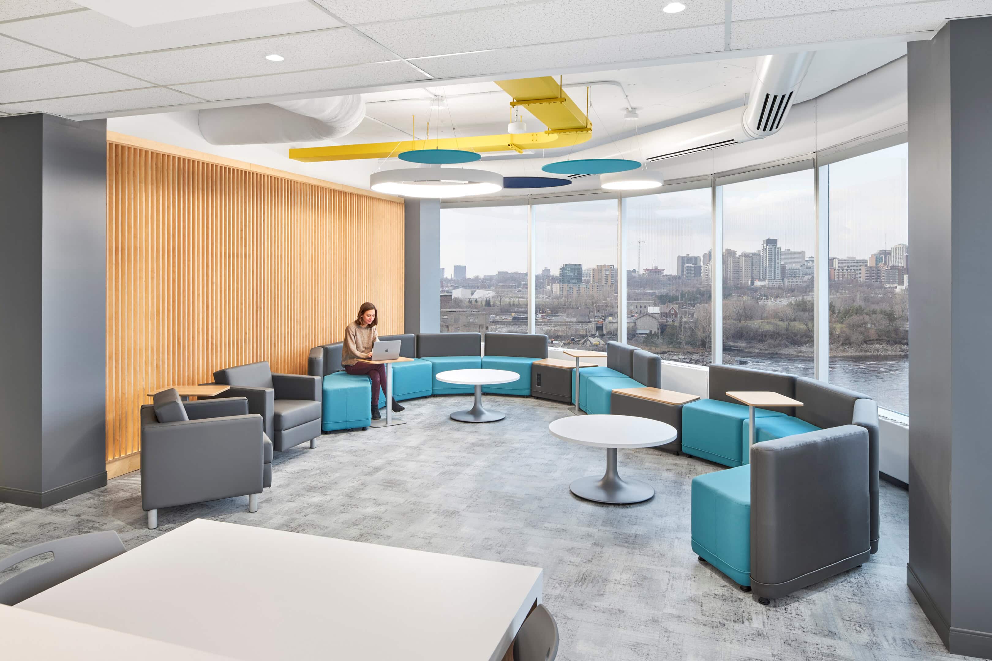Lounge lighting with decorative ceiling cloud near windows at GC Workplace, Ottawa
