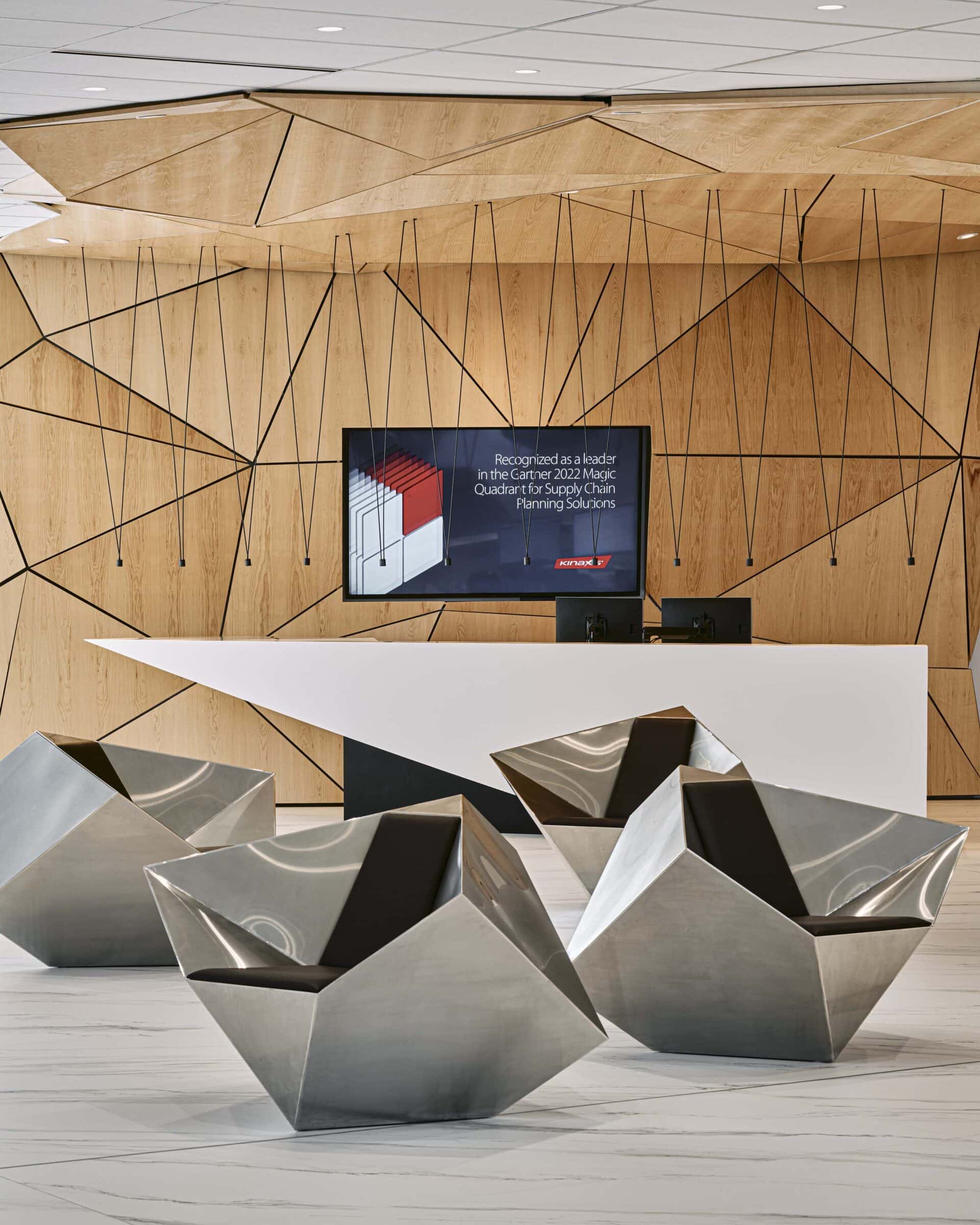Vibia Match pendant cluster above the reception desk at Kinaxis headquarters, Kanata, against a faceted timber feature wall