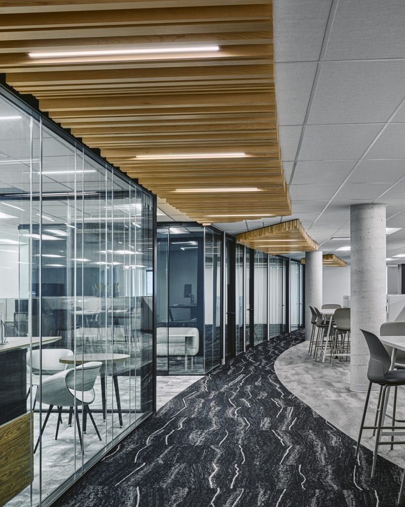 Glazed meeting room spine at Kinaxis with recessed Delta Light Femtoline linear fixtures inside timber slat ceiling rafts