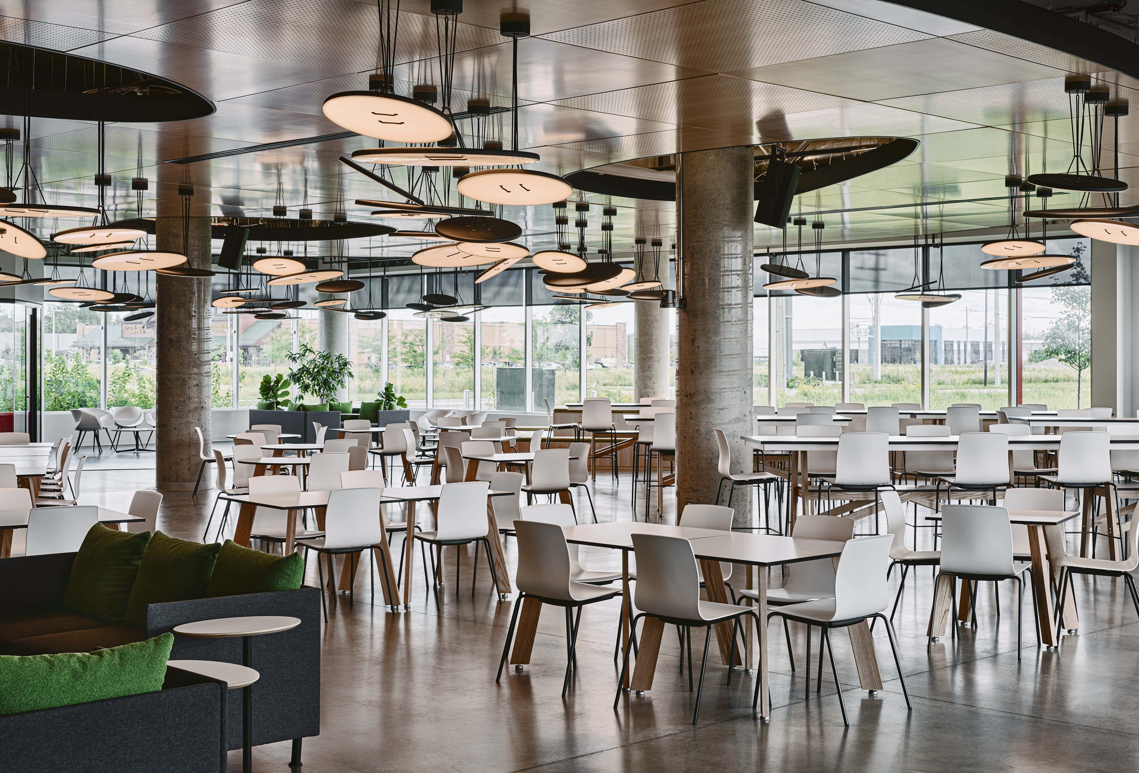 The Hive dining hall at Kinaxis headquarters lit by eighty-two A-N-D Button pendants at staggered heights above the tables