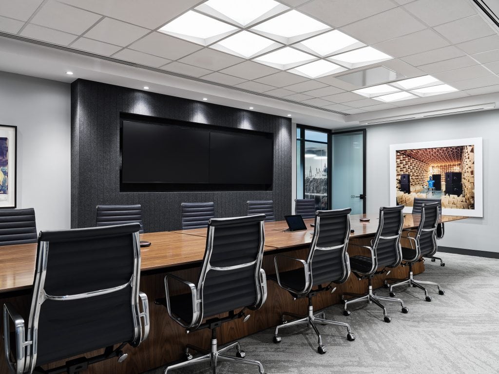 Boardroom at Osler in Ottawa lit by a measured grid of recessed ceiling luminaires over the conference table.