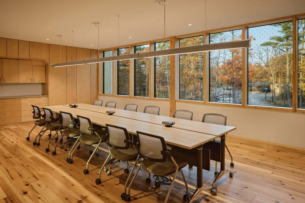 Liteline Sigma2 recessed downlights over the meeting-room table at Forest and Nature School, Ottawa, with forest views.