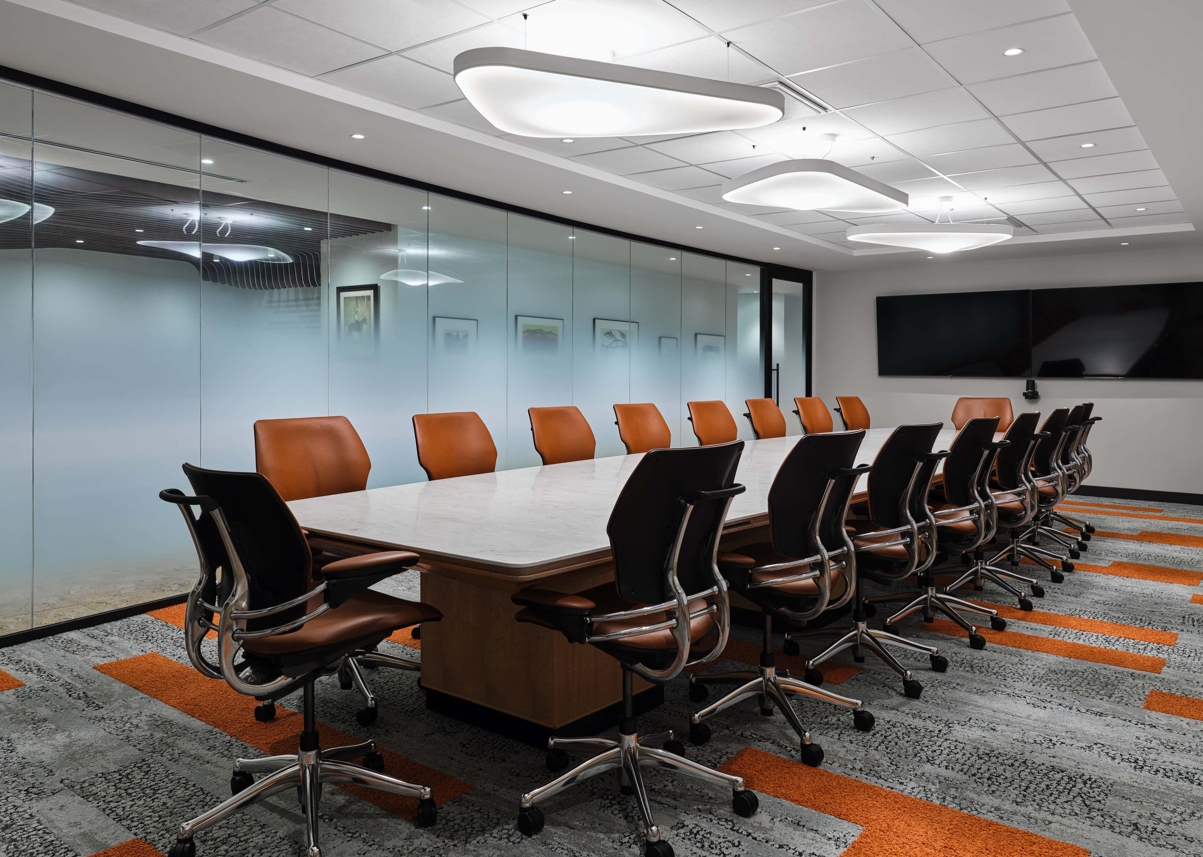 Boardroom lighting with suspended linear fixtures at Office of the Commissioner of Indigenous Languages (OCIL), Ottawa