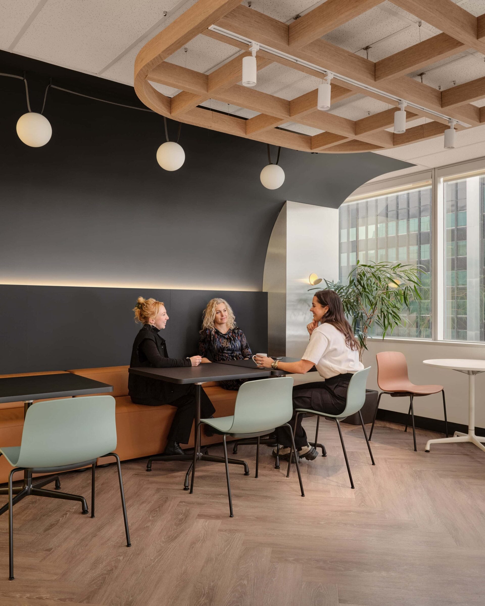 Three white Vibia globe pendants over the staff lounge banquette at the Federation of Law Societies