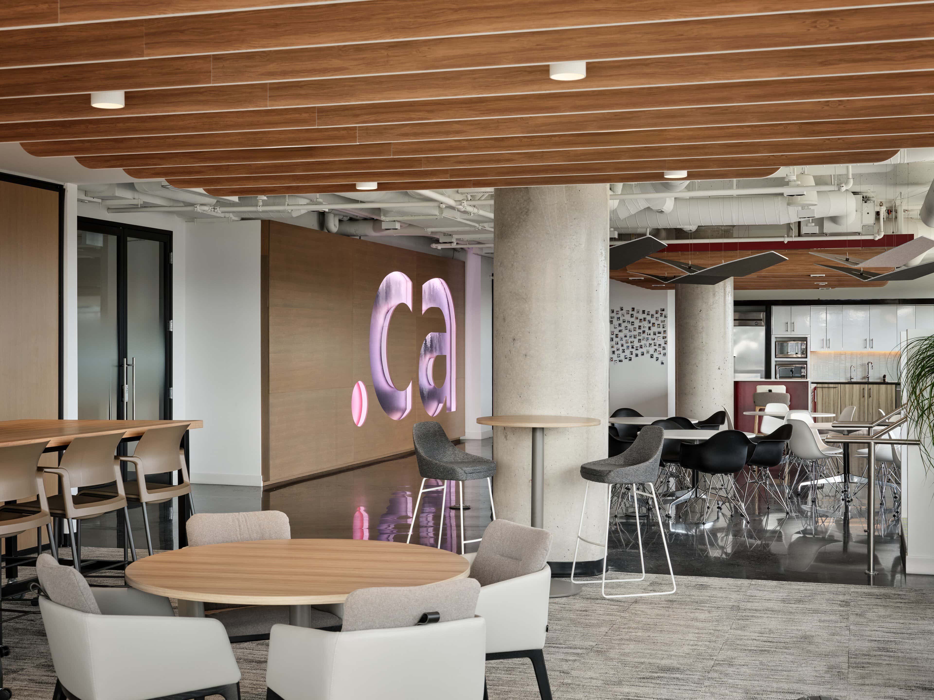 The backlit .ca feature wall seen from the cafe collaboration tables at CIRA, Ottawa