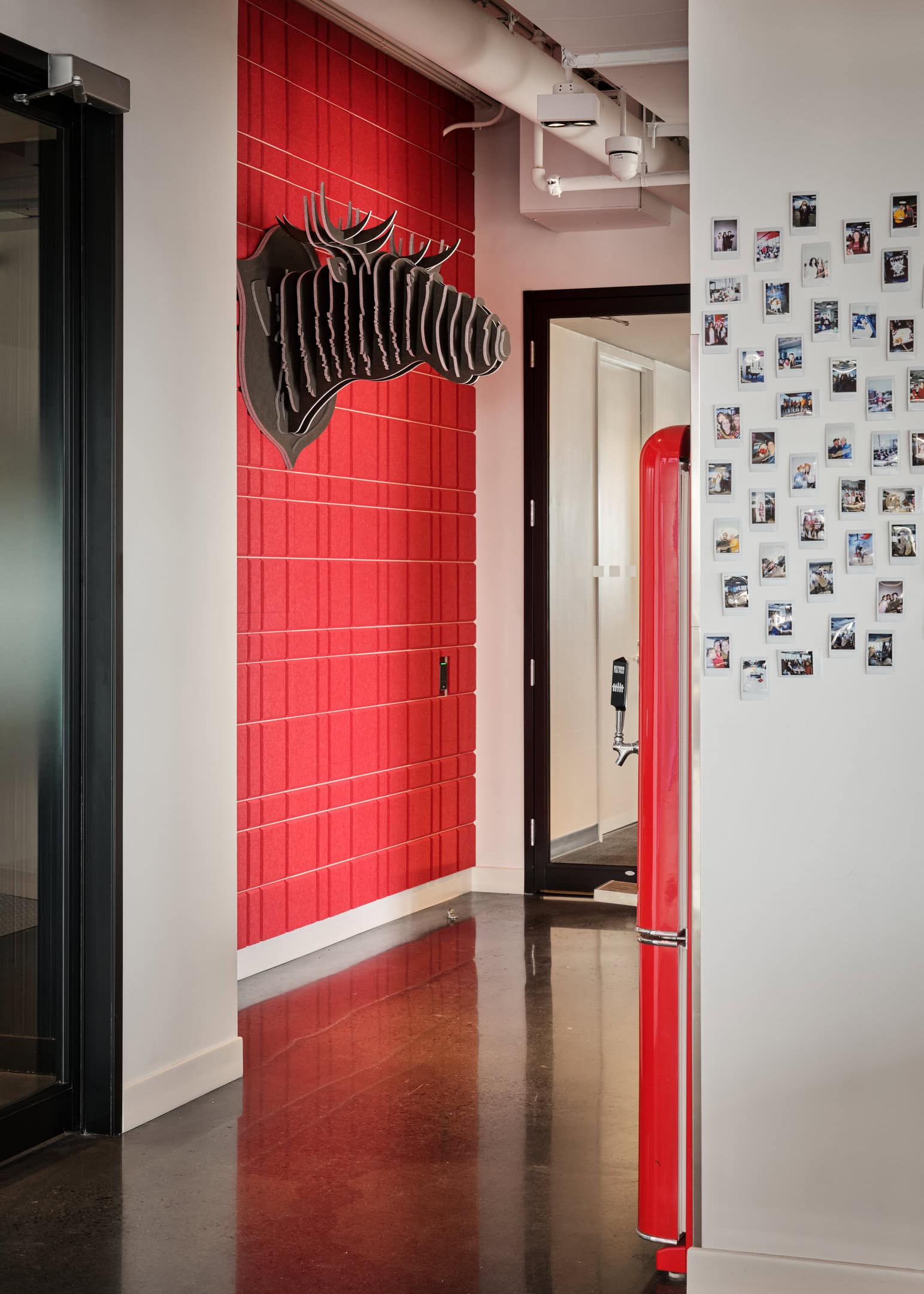 Decorative zebra head wall art on red tiled wall.