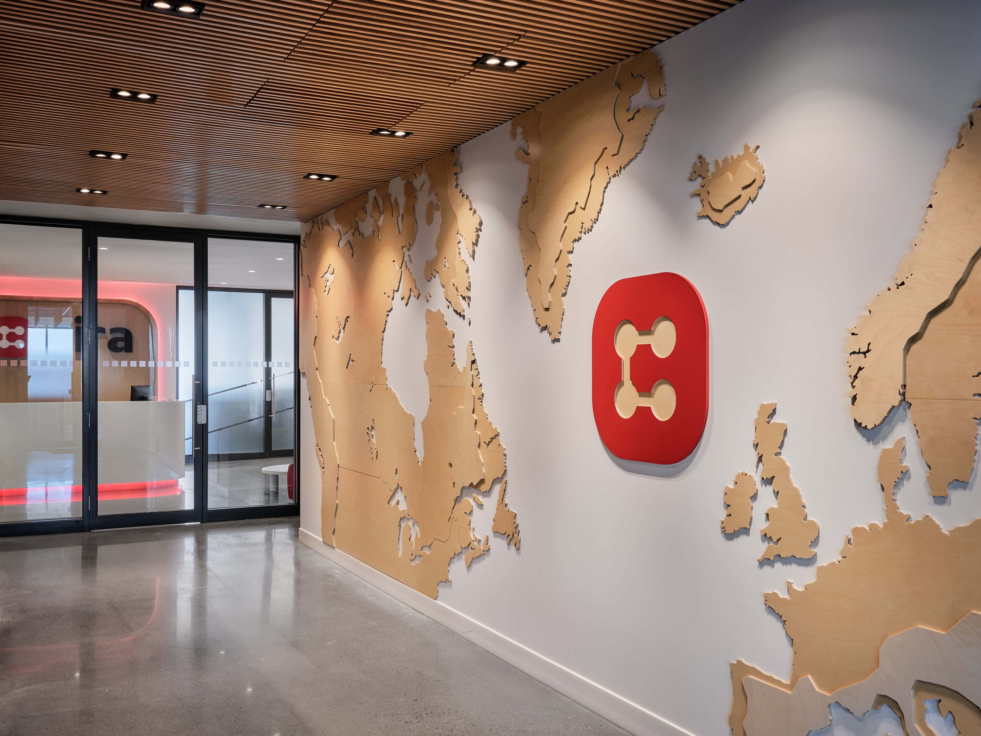 Elevator lobby with a wooden world-map wall and the CIRA logo, Ottawa