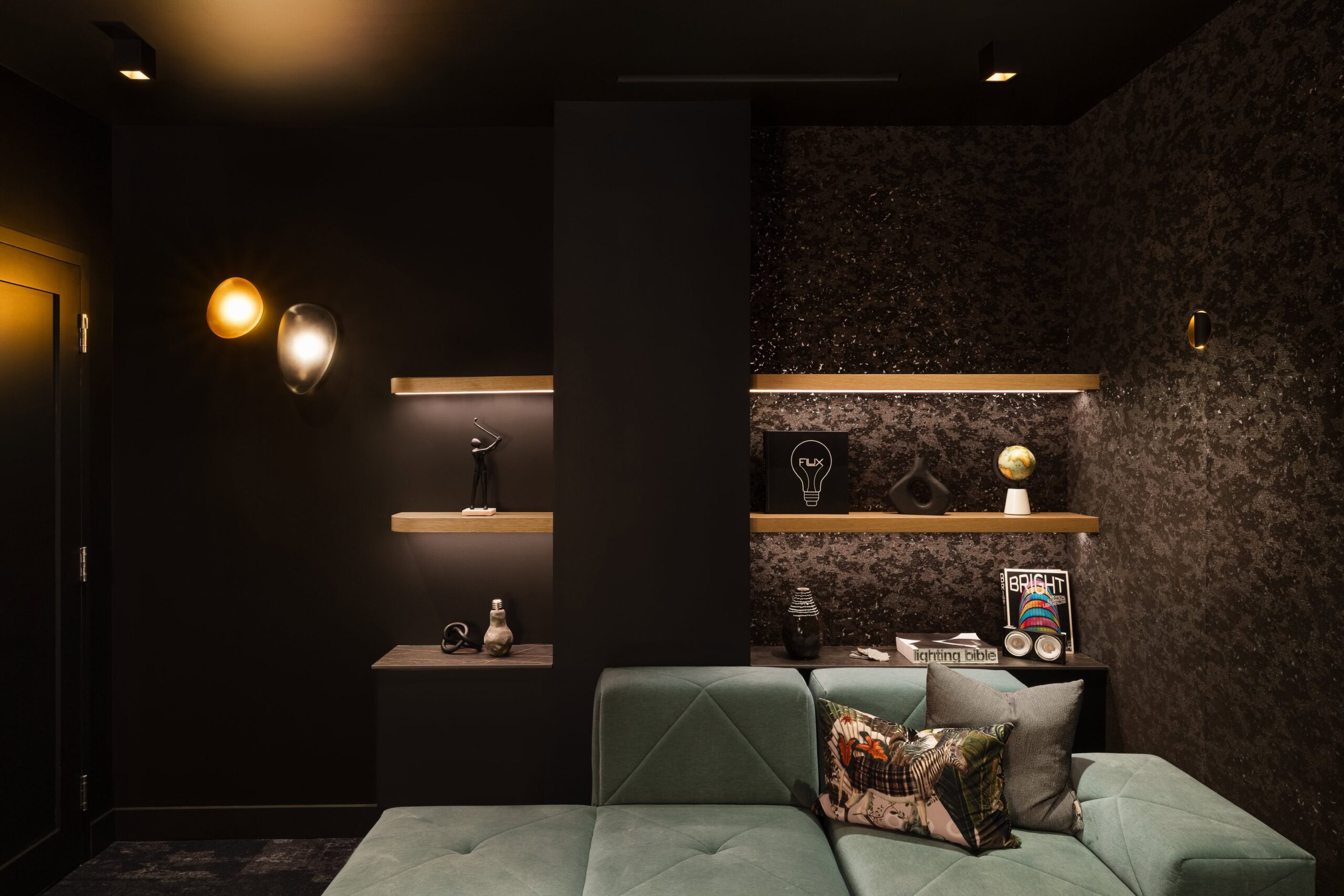 Flux Lighting showroom, Ottawa — media room dimmed low with small-aperture fixtures and shelf lighting, no glare.