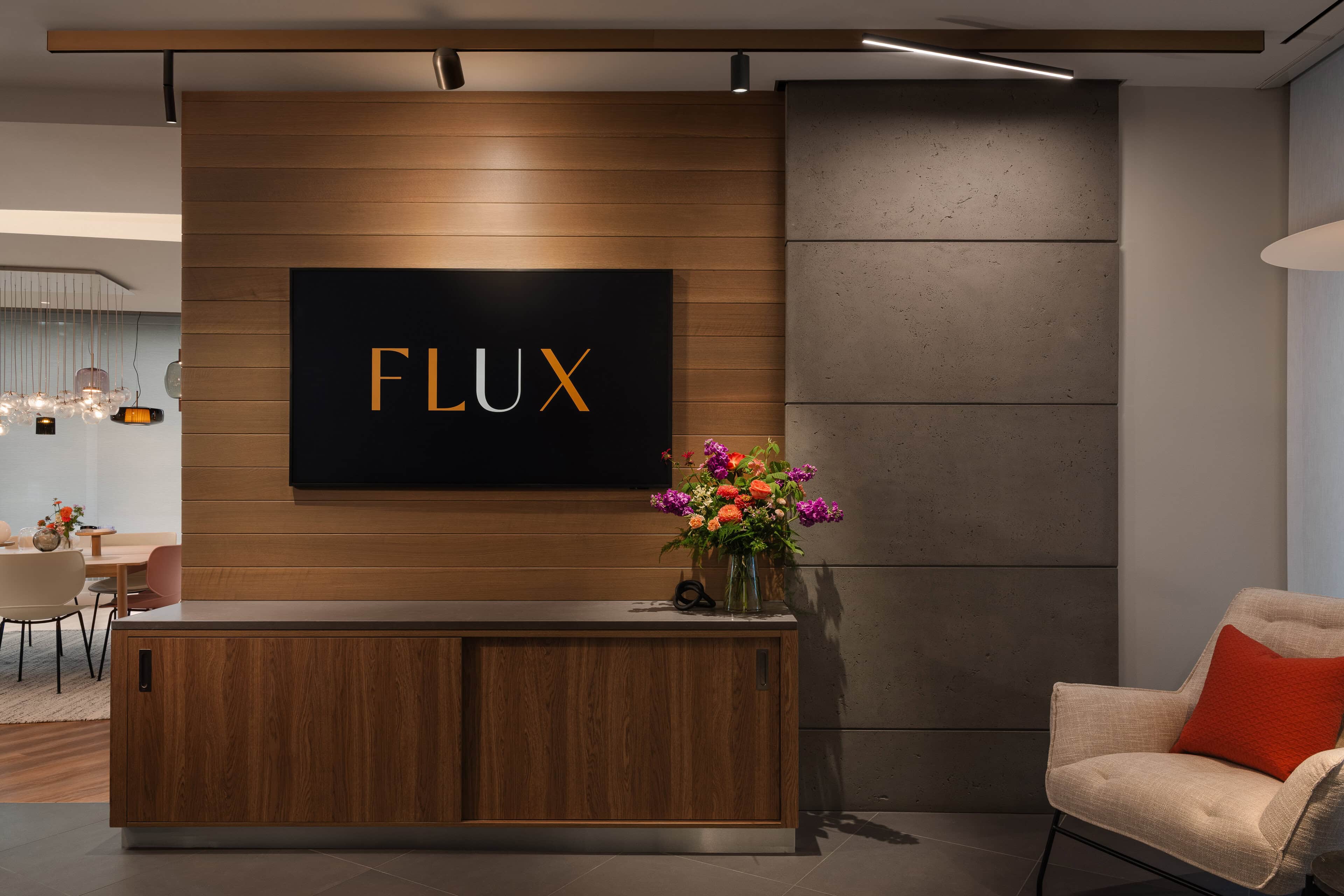 Flux Lighting showroom, Ottawa — the Flux brand wall by the entrance, with the reception desk beside it.