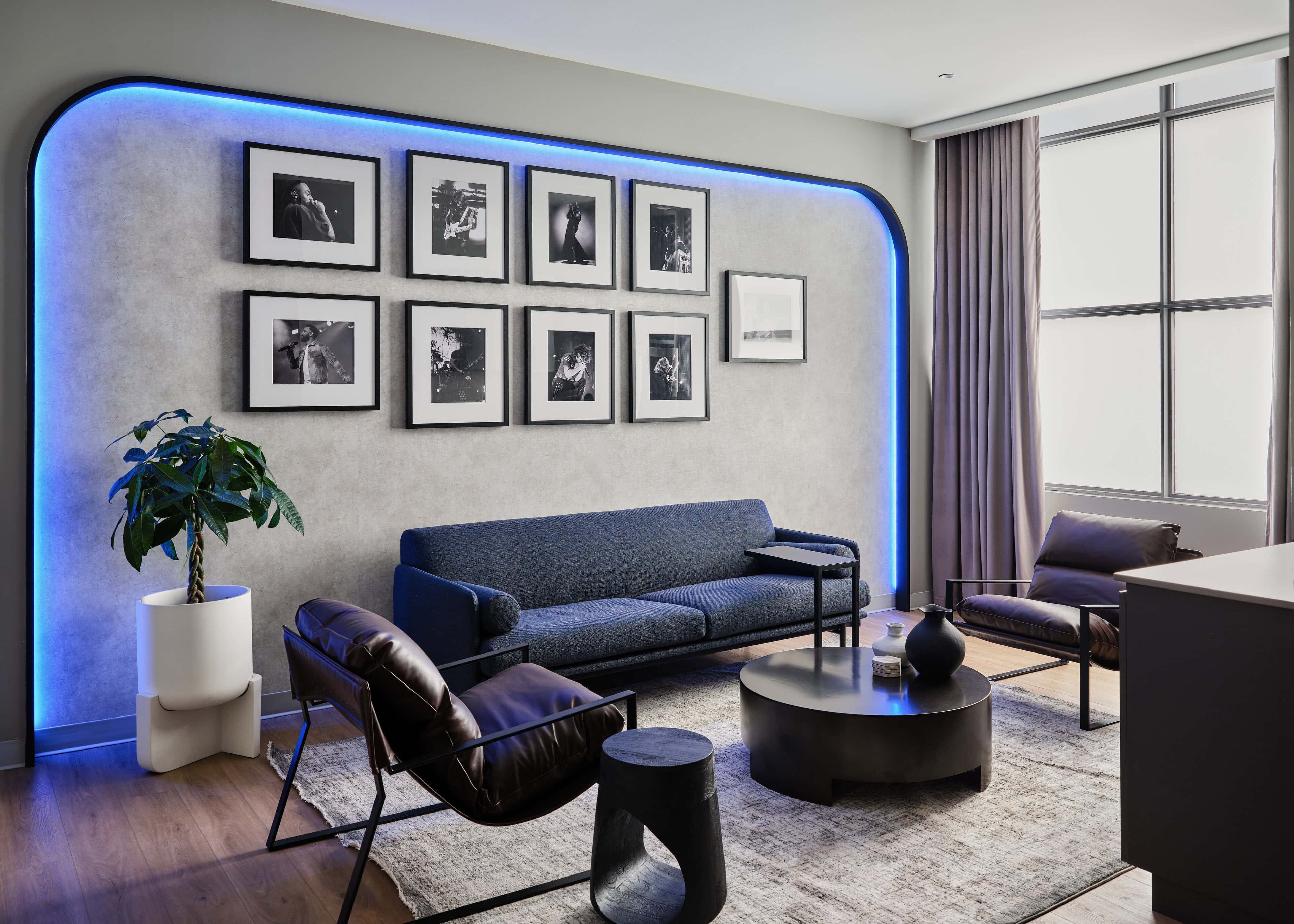 Artist lounge at HISTORY Ottawa with a blue halo of light behind the gallery wall