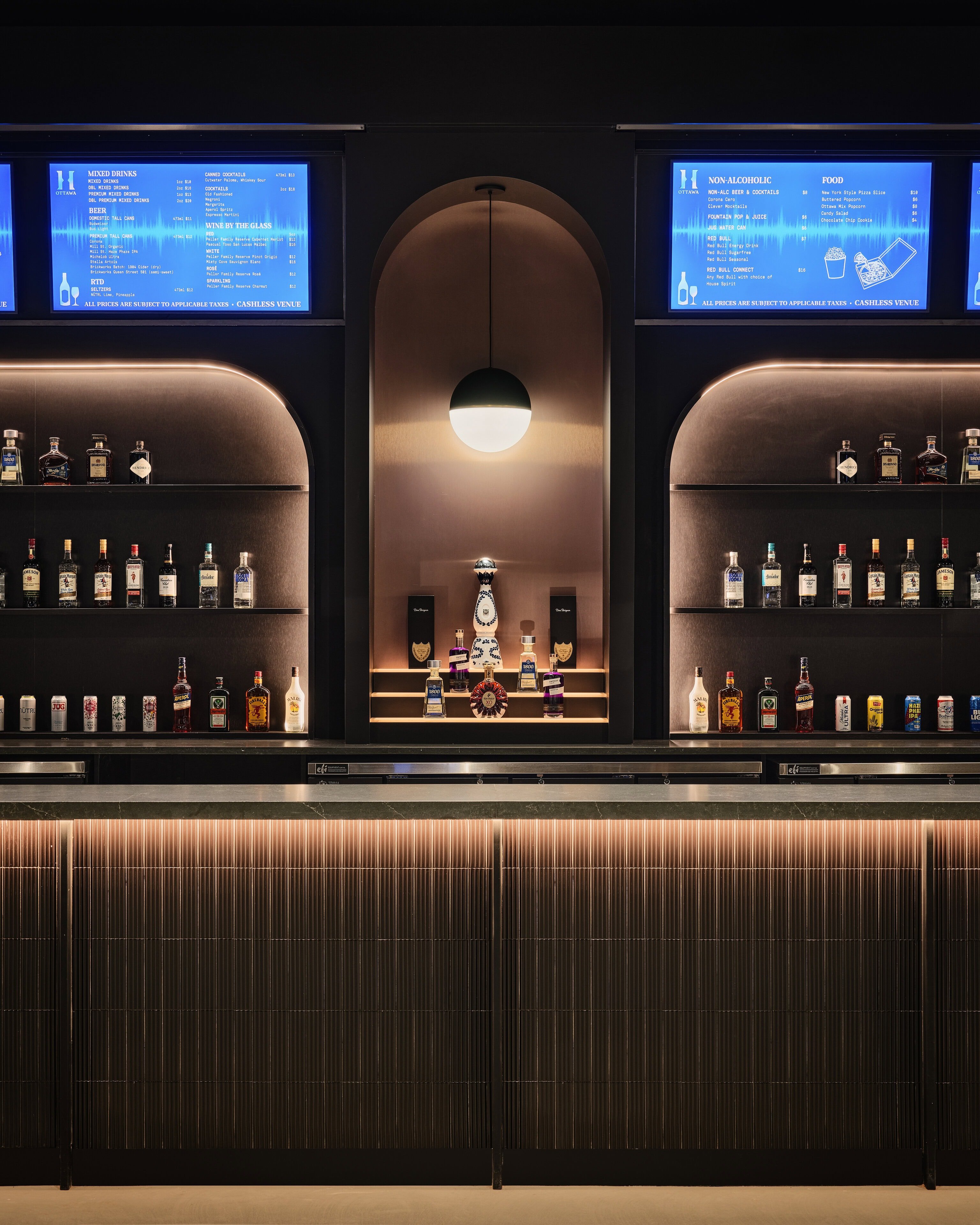 Close view of a Visual Comfort Akova globe pendant with a Ketra lamp above the backbar at HISTORY Ottawa