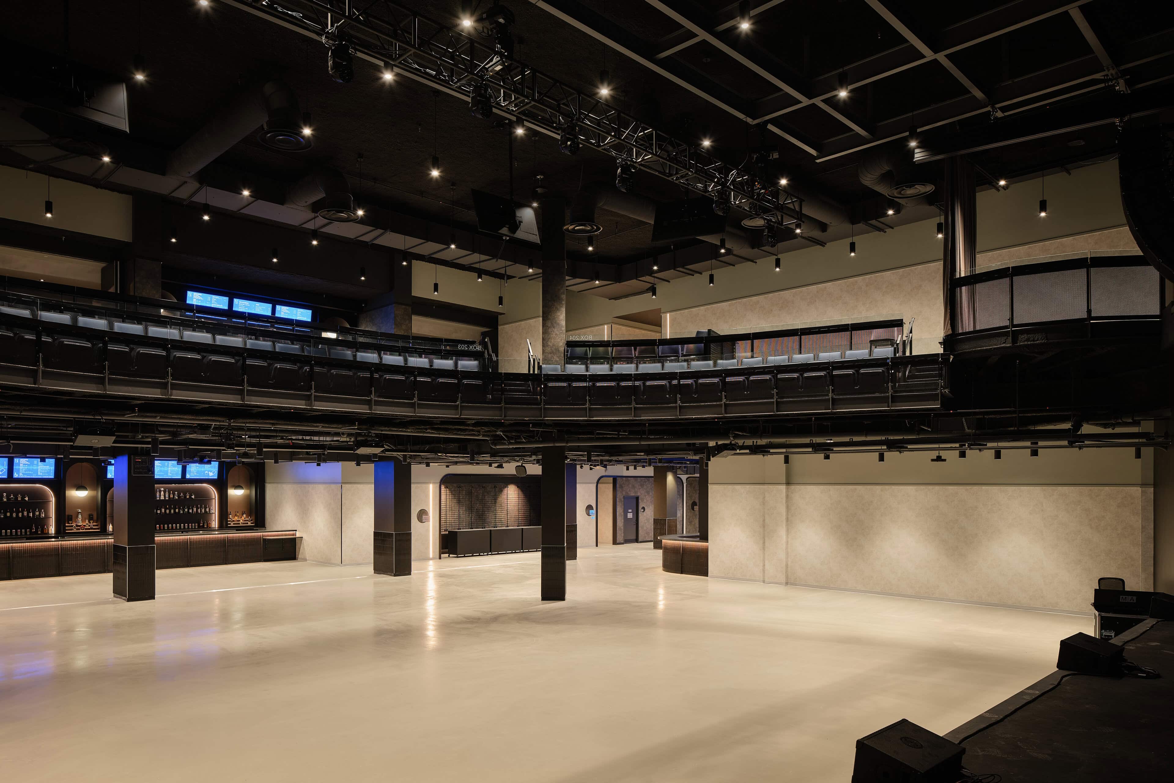 The main hall at HISTORY Ottawa with house lights up, the floor and back wall evenly lit and the balcony ring above
