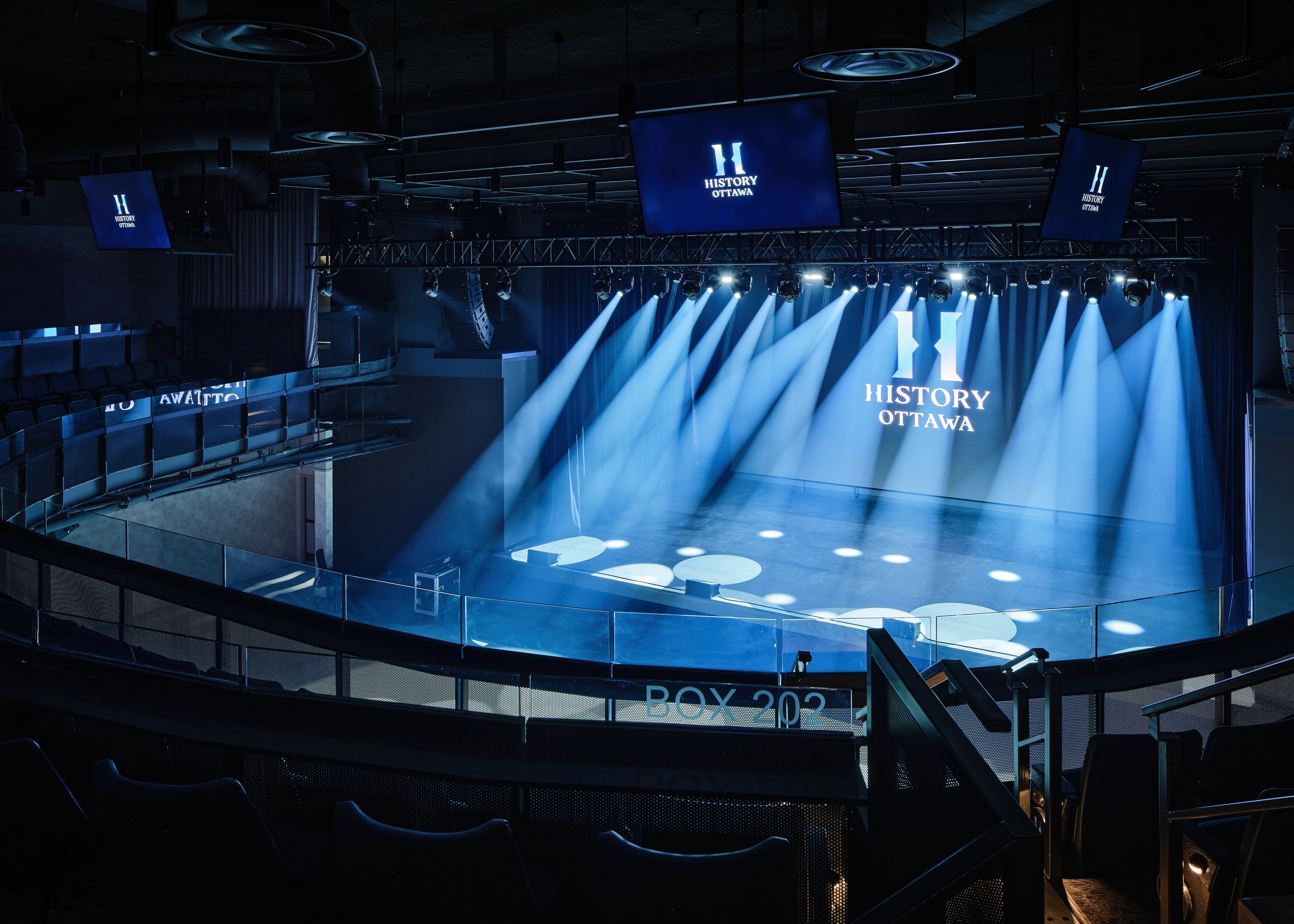 The main hall at HISTORY Ottawa in show mode, the architectural lighting down and the room reduced to the stage