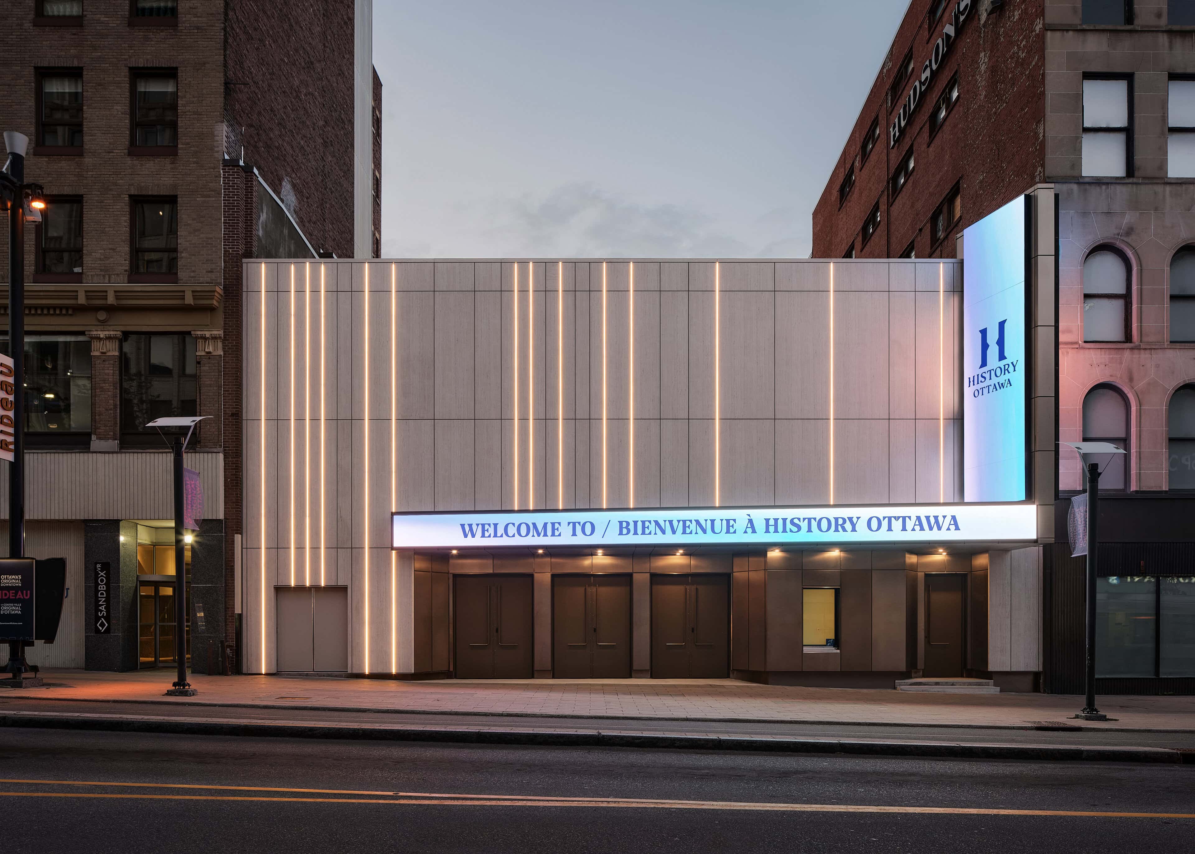 Vertical LED Linear Venus TC runs lighting the full height of the Rideau Street facade at HISTORY Ottawa, above the illuminated marquee