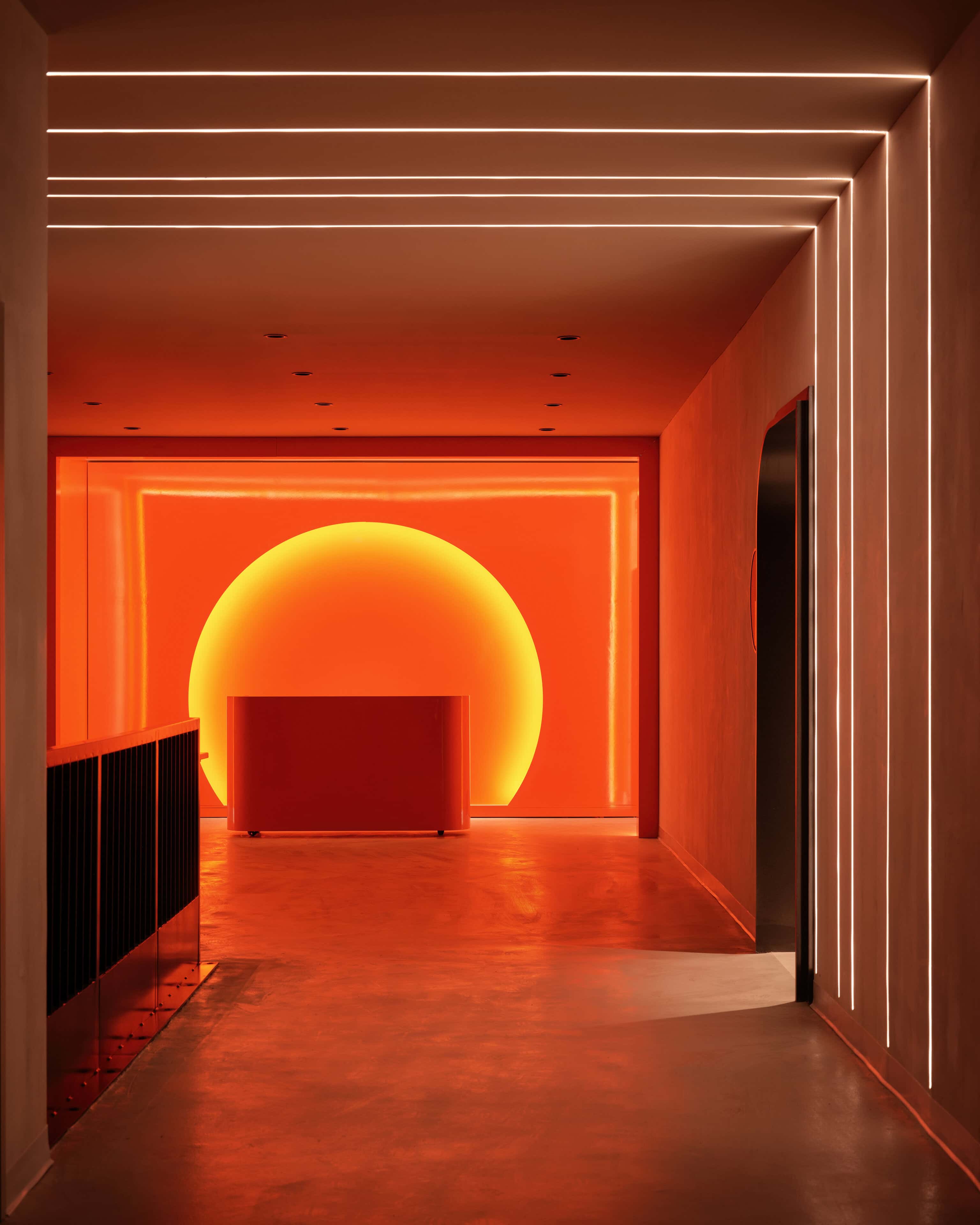 The sunset room at HISTORY Ottawa, wall lines of light converging on a large glowing disc