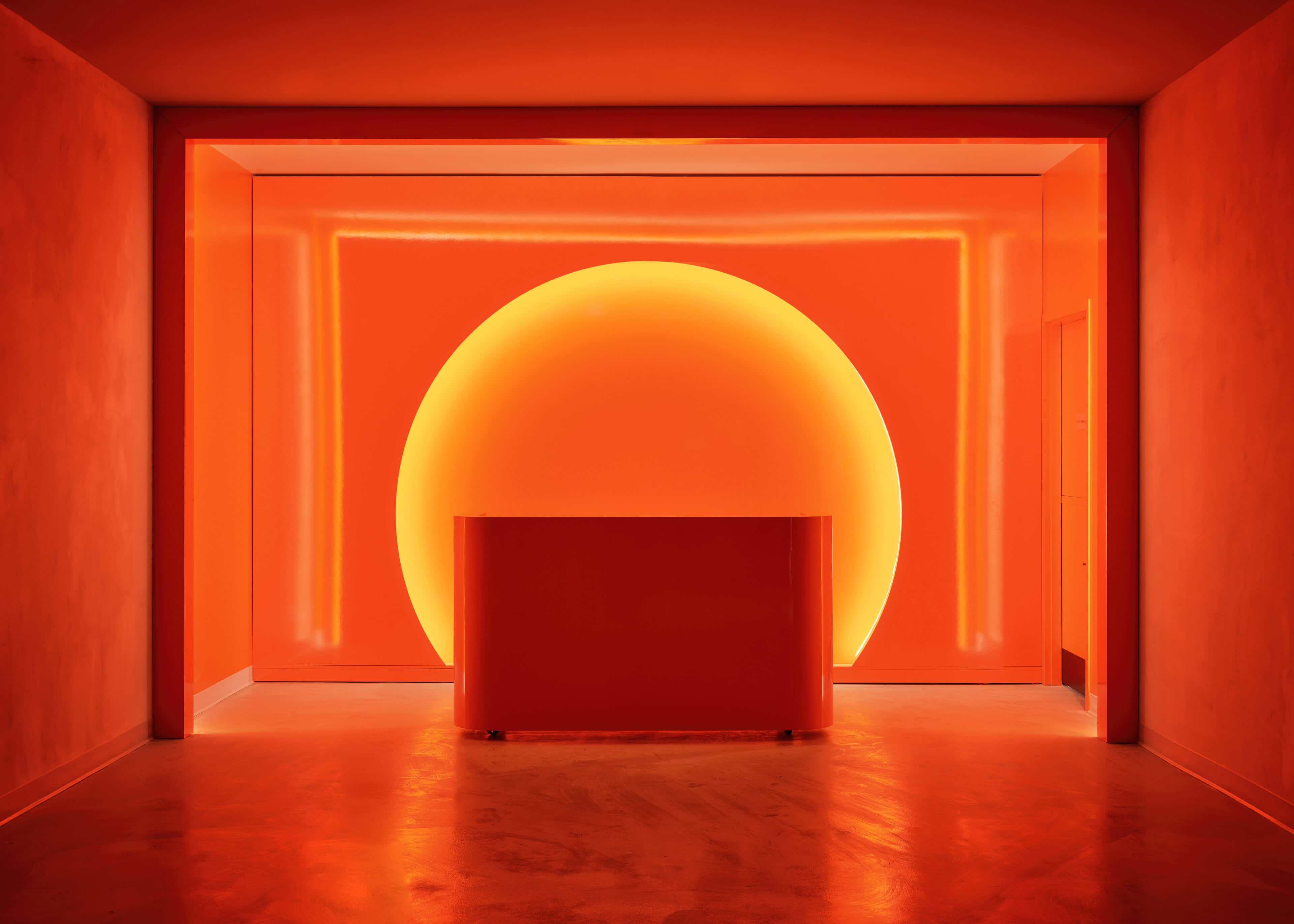 Saturated orange room at HISTORY Ottawa with nested wall lines of light receding toward an illuminated disc