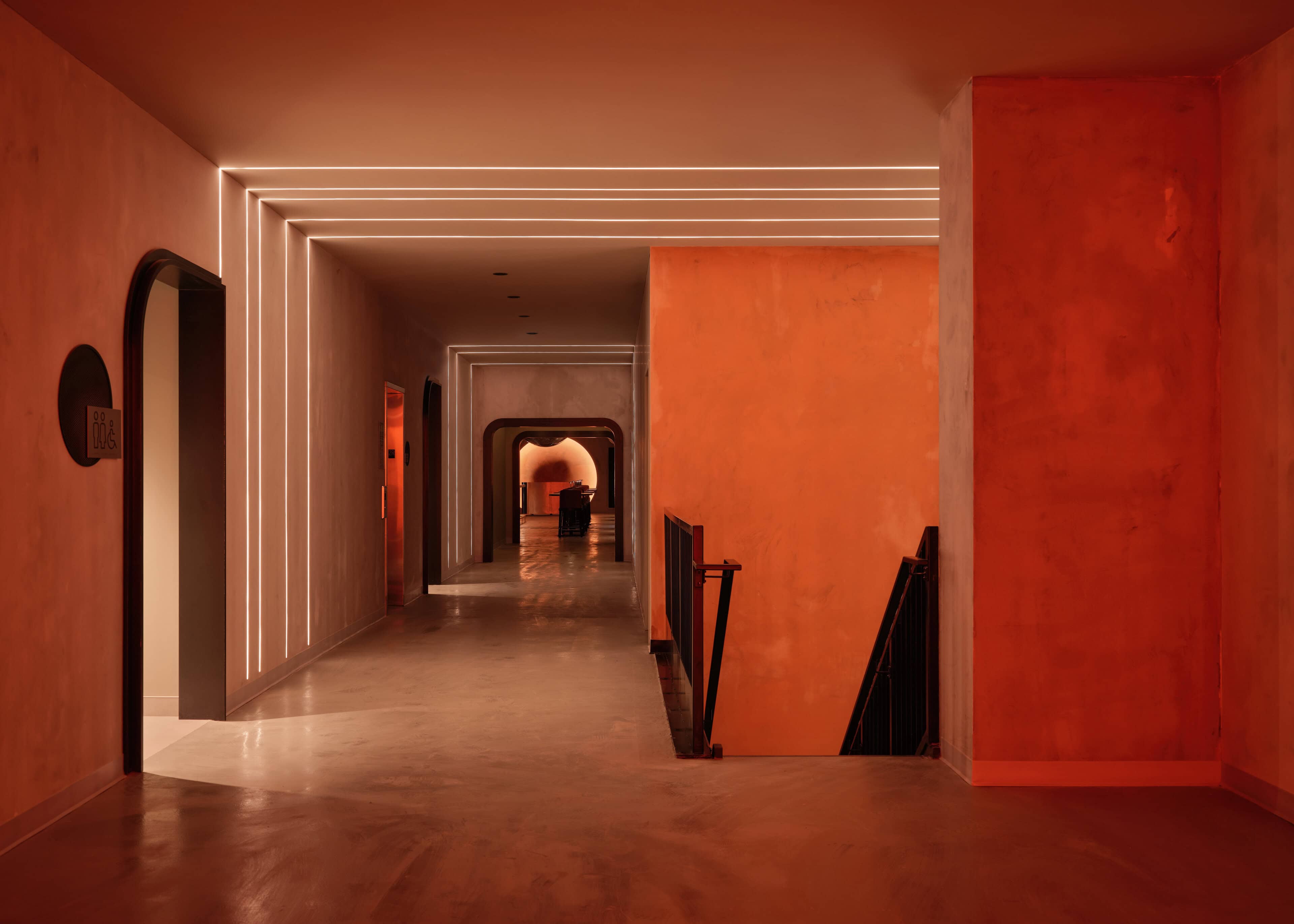 PureEdge TruLine runs forming nested rectangular frames of light along the terracotta corridor at HISTORY Ottawa