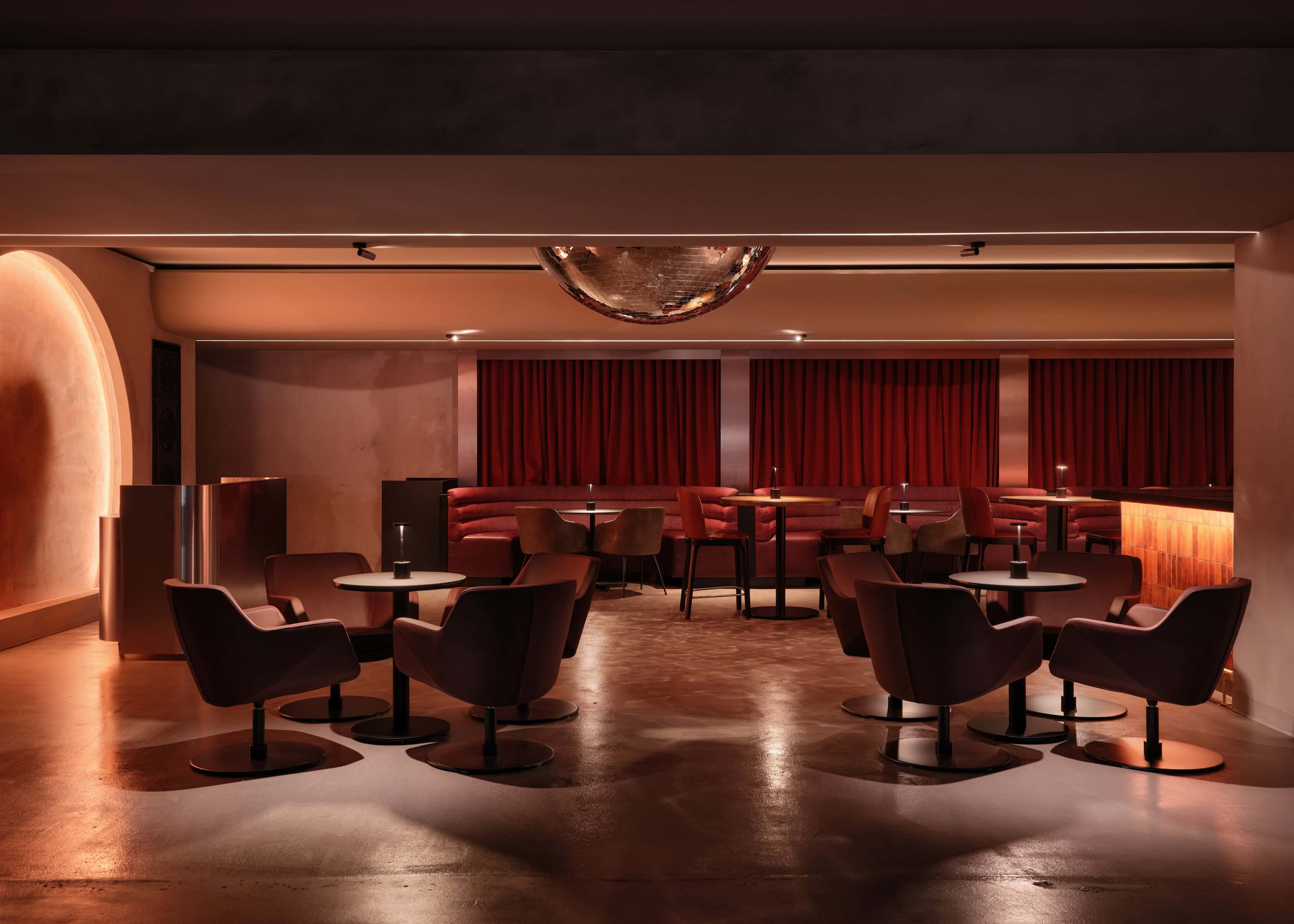 VIP lounge at HISTORY Ottawa with a red banquette and a mirrored dome set into the ceiling