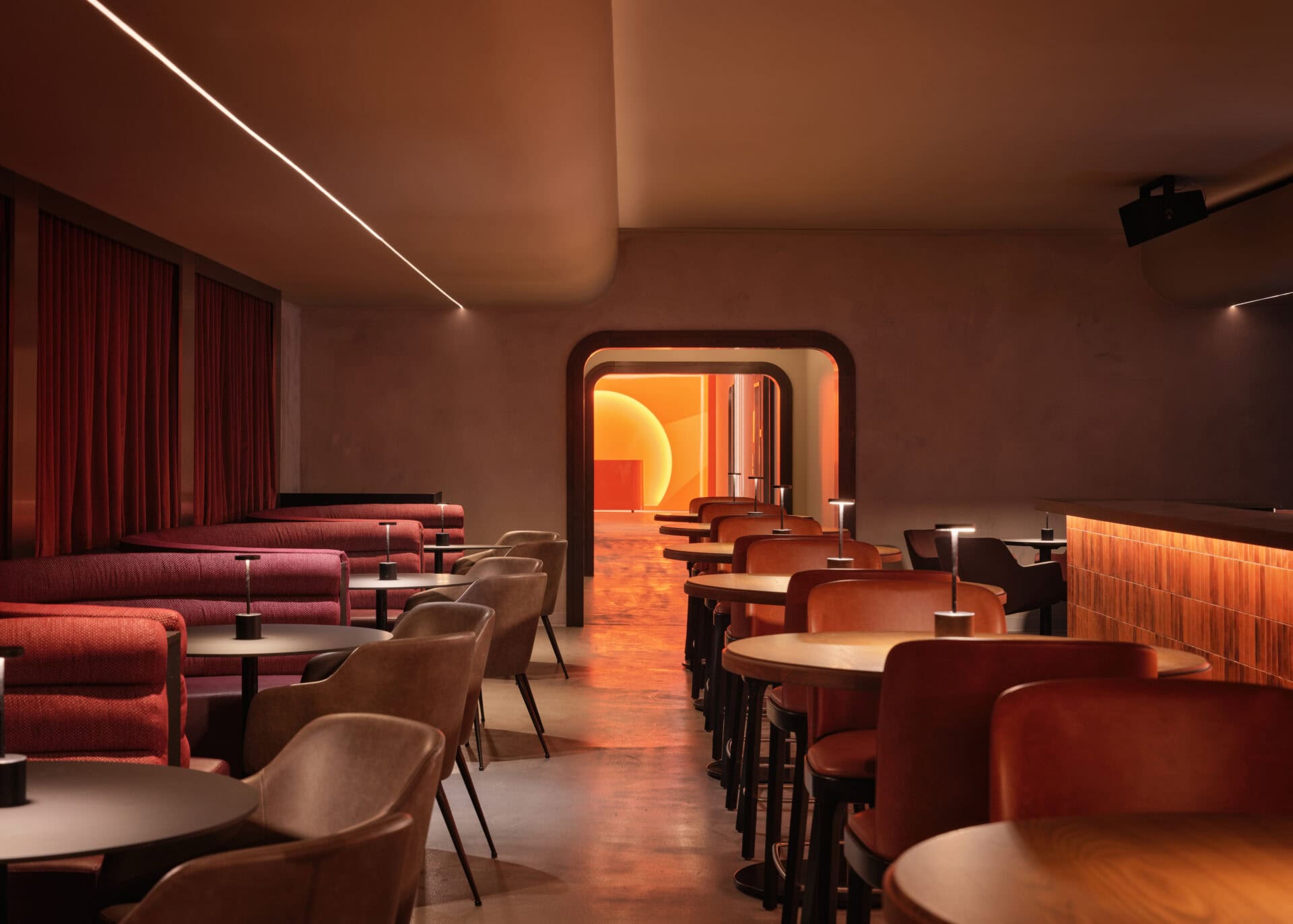 A VIP room at HISTORY Ottawa with a glowing arched opening at the far end and a linear run across the ceiling