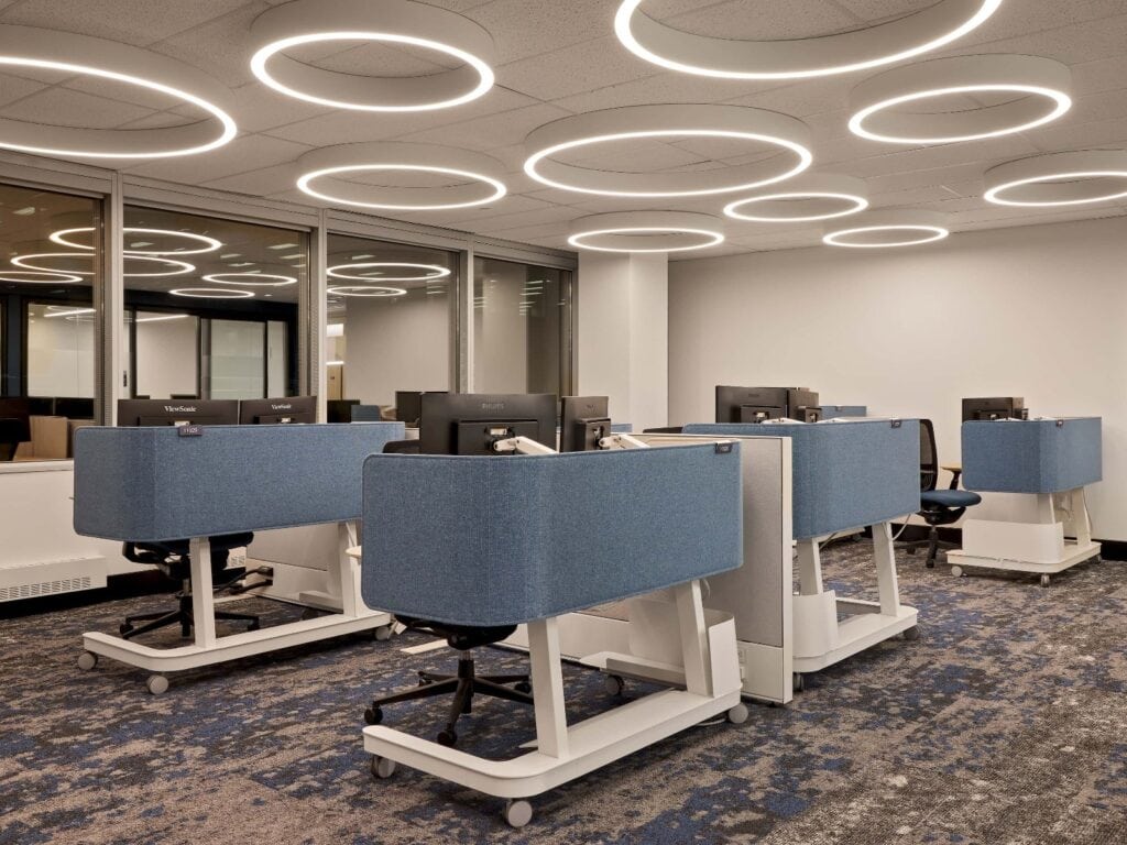 Illuminated ring fixtures across the ceiling of an open-plan office of workstations at Canadian Commercial Corporation, Ottawa.